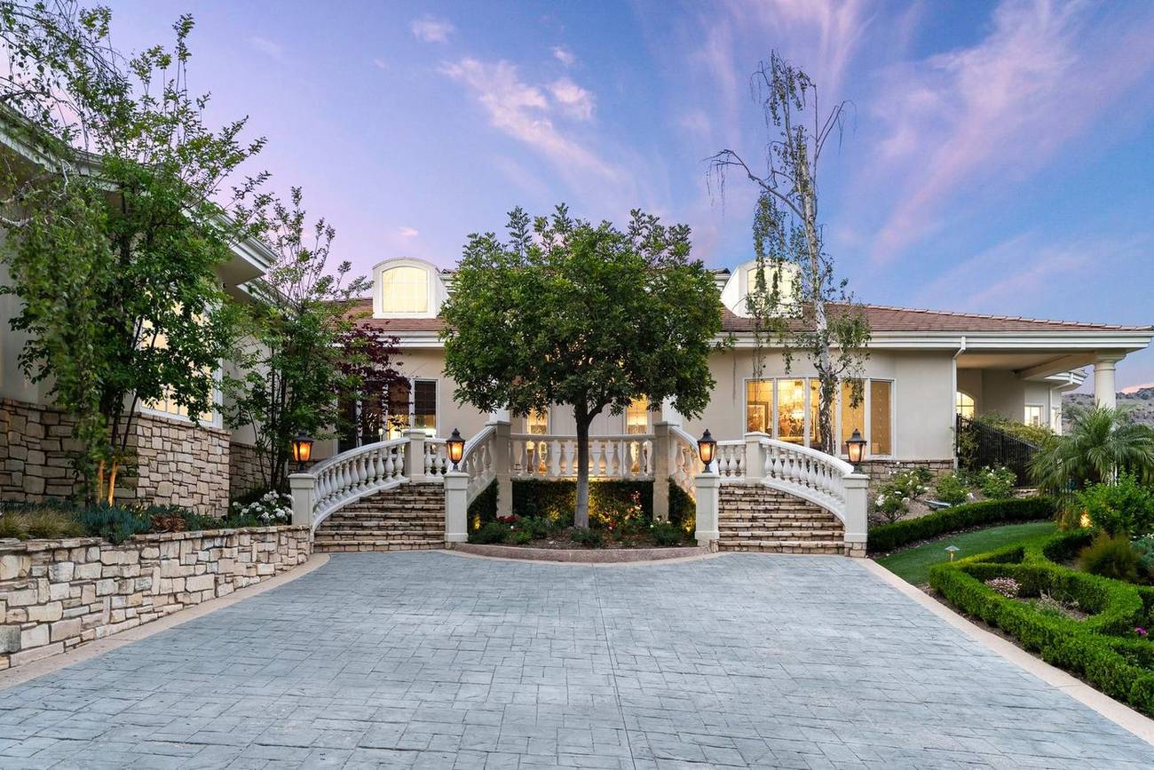 1403 Kingsboro Court — twin staircases and rose garden at twilight