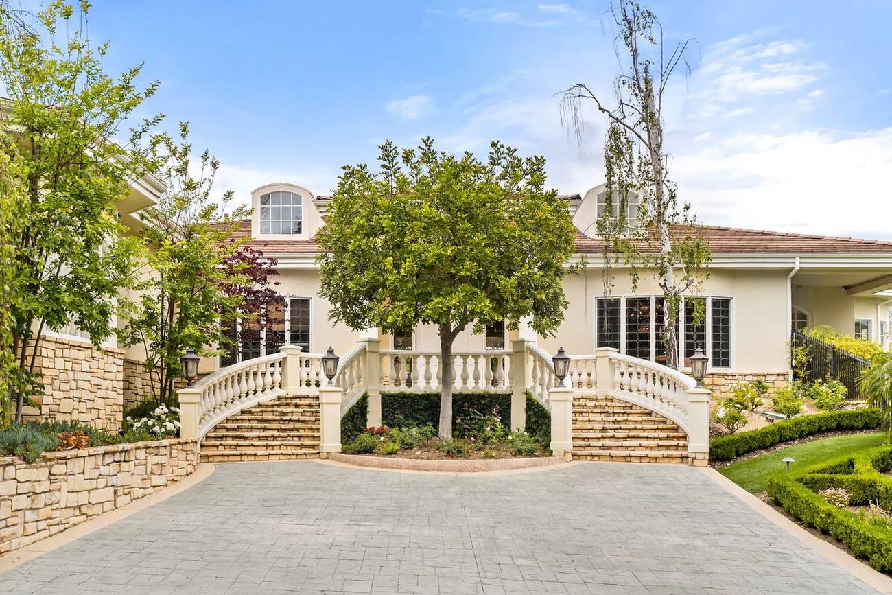 1403 Kingsboro Court — gated arrival and twin staircases