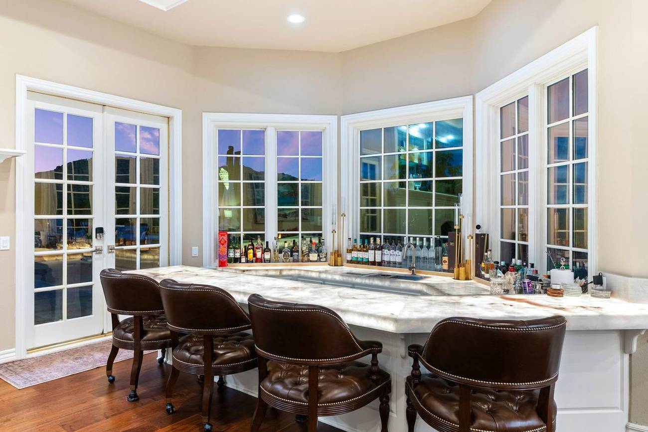 1403 Kingsboro Court — backlit onyx bar glowing at dusk