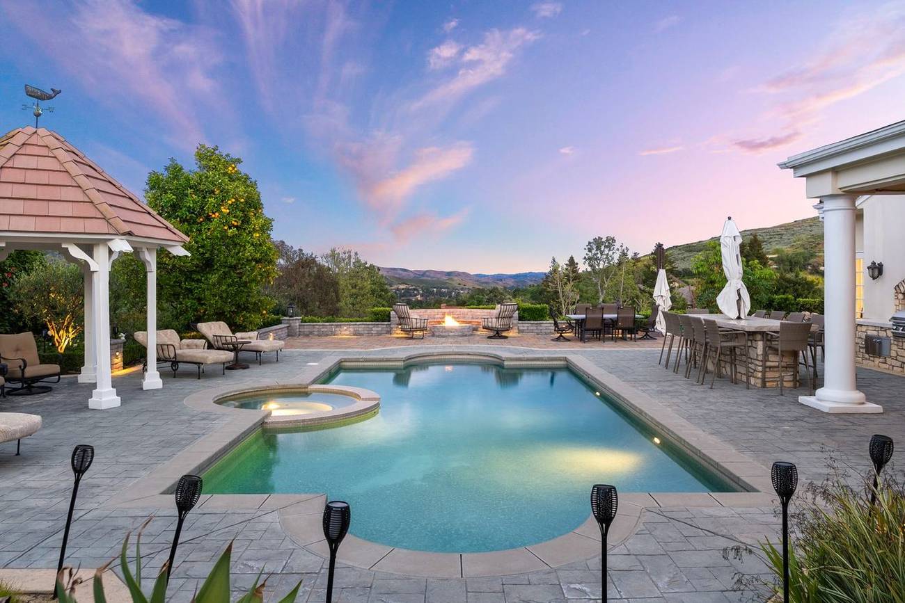 1403 Kingsboro Court — pool and gazebo under a sunset sky