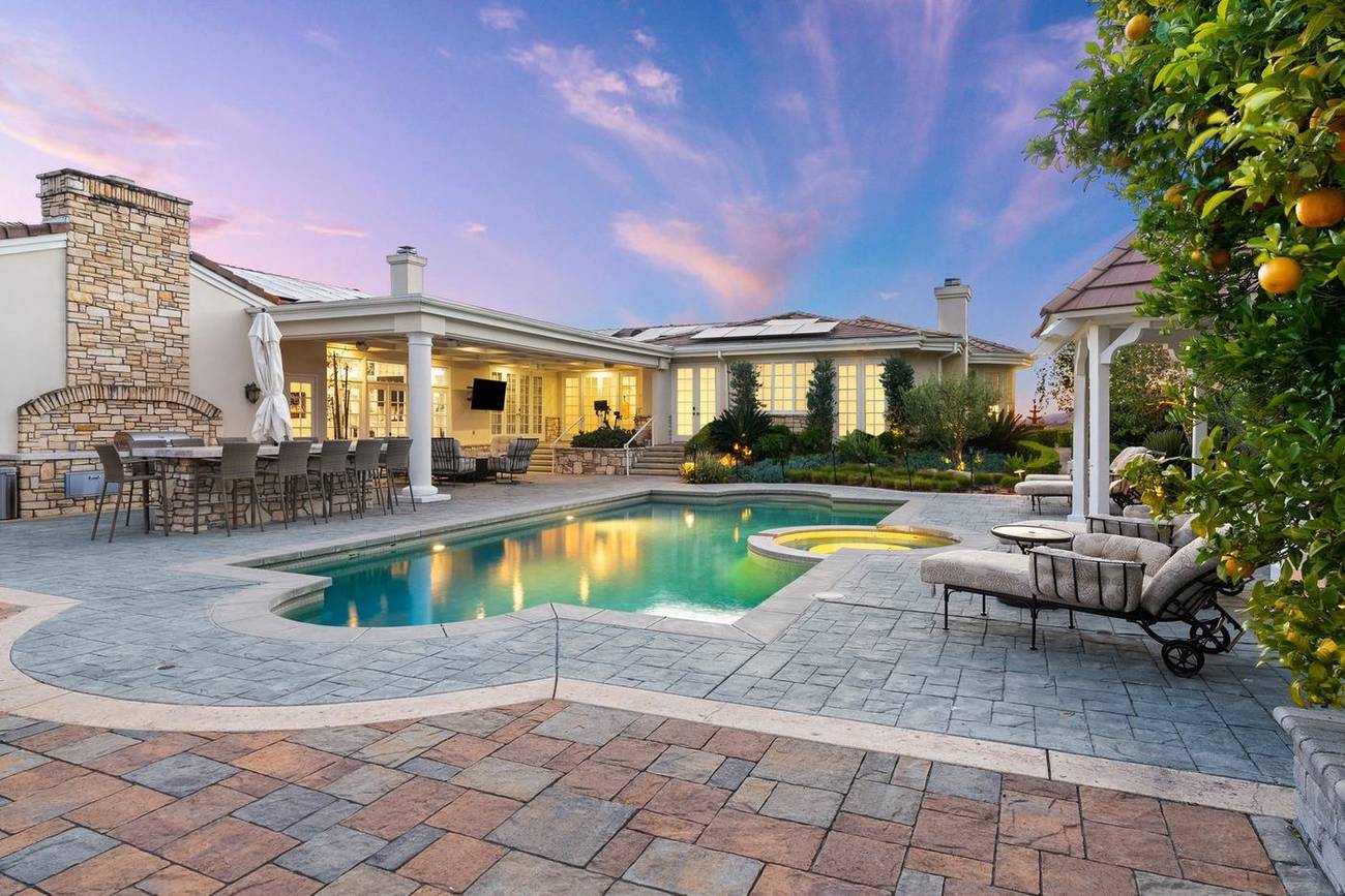 1403 Kingsboro Court — the estate across the pool at twilight