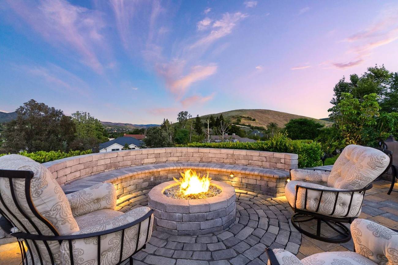 1403 Kingsboro Court — fire pit glowing against the sunset