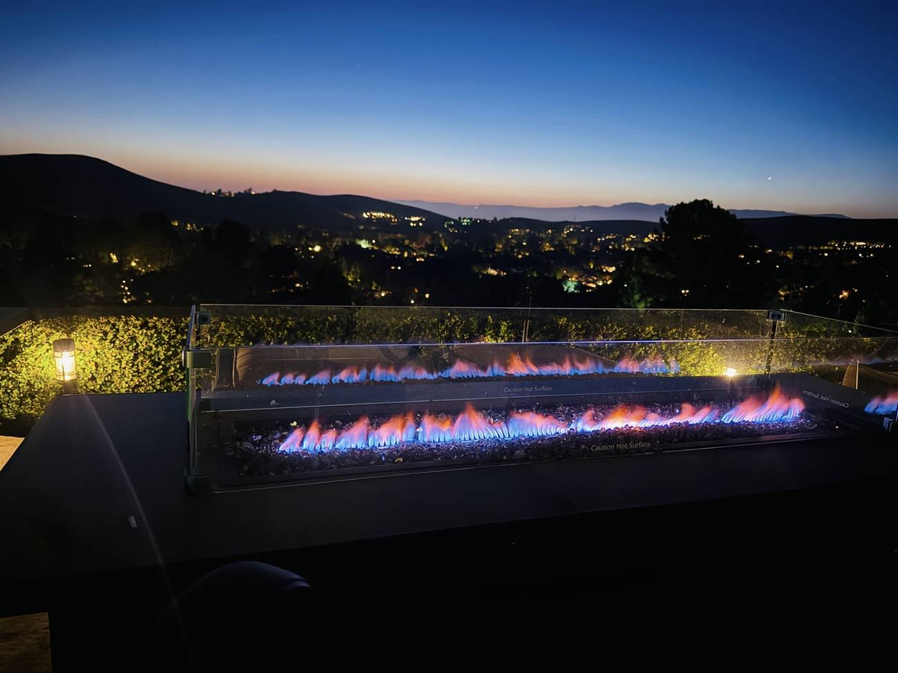 1403 Kingsboro Court, linear fire pit against the city lights and sunset